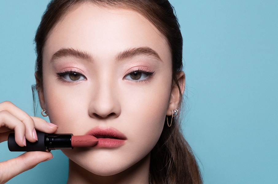 Closeup of model applying our iconic Velvet Teddy Matte Lipstick