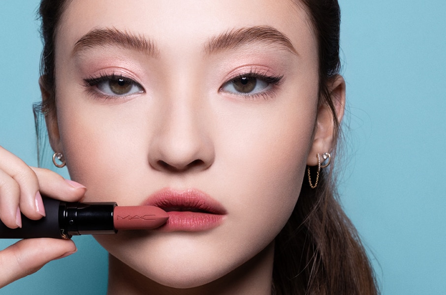 Closeup of model applying our iconic Velvet Teddy Matte Lipstick